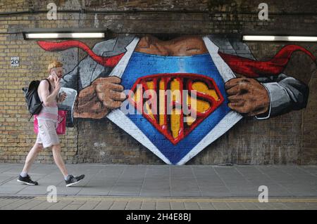 Ein Mann geht an einem NHS-Superman-Graffiti des Straßenkünstlers Lionel Stanhope vorbei, um den NHS-Arbeitern von Waterloo, London, Tribut zu zollen, während das Vereinigte Königreich weiterhin im Lockdown ist, um die Ausbreitung des Coronavirus einzudämmen. Bilddatum: Freitag, 8. Mai 2020. Stockfoto