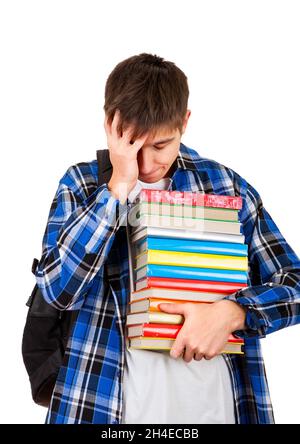 Trauriger und müder Student mit den auf dem weißen Hintergrund isolierten Büchern Stockfoto