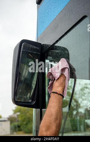 Augsburg, Deutschland. Okt. 2021. Ein Mann reinigt einen Bus des Stadtwerke Augsburg, der mit Erdgas/komprimiertem Erdgas (CNG) betrieben wird. Quelle: Finn Winkler/dpa/Alamy Live News Stockfoto