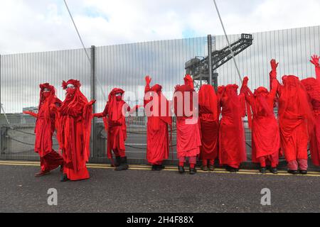 Glasgow, Schottland, Großbritannien, November 02 2021. Extinction Rebellion rot umarmte Demonstranten reisen in einer Prozession durch die Stadt zu den COP 26 Barrikaden, hinter denen sich die Staats- und Regierungschefs der Welt versammeln, um ihre Reaktion auf den Klimawandel zu diskutieren Stockfoto