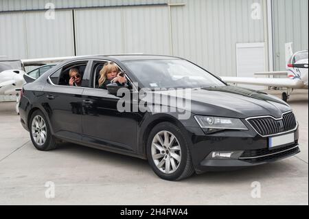 Professionelle bewaffnete Team von weiblichen und männlichen Bodyguards schießen und schützen eine VIP-Prominenten Person in der Auto-Limousine. Bodyguard und VIP Person Security Pro Stockfoto