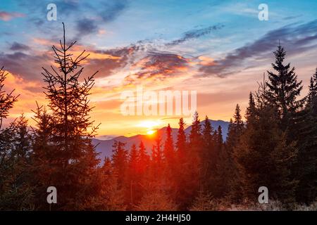 Die Sonne versteckt sich hinter den Bergen, der Sonnenuntergang in den Bergen Stockfoto