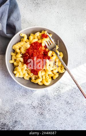 Schüssel mit Cavatappi-Pasta mit Tomatensauce und geriebenem Parmesankäse Stockfoto