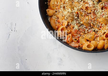 Hausgemachte Bucatini alle Amatriciana Pasta auf einer weißen Holzoberfläche, Draufsicht. Flach liegend, über Kopf. Platz für Text. Stockfoto