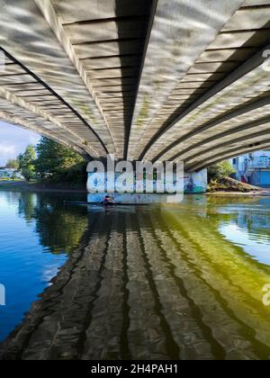 Die Donnington Bridge überquert die Themse stromaufwärts von Oxford. Hier sehen wir abstrakte Spiegelungen von gewelltem Wasser auf seiner Unterseite auf einem feinen Autu Stockfoto