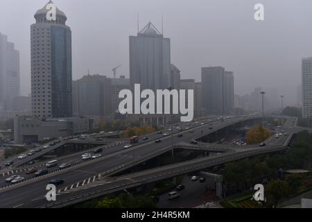 Peking, China. November 2021. Die Hochhäuser in Pekings zentralem Geschäftsviertel (CBD) sind von grauer Luftverschmutzung umhüllt.Peking ist aufgrund einer Smog-Runde, die die Stadt vom 4. November getroffen hat, von widrigen meteorologischen Bedingungen und der Übertragung regionaler Umweltverschmutzung betroffen und wird laut den lokalen Behörden bis zum 6. November voraussichtlich noch andauern. Peking begann die gelbe Warnung vor schwerer Luftverschmutzung um 16:00 Uhr am heutigen Tag. (Foto von Sheldon Cooper/SOPA Images/Sipa USA) Quelle: SIPA USA/Alamy Live News Stockfoto