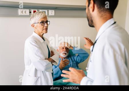 Der Arzt bespricht die Diagnose mit dem besorgten älteren Patienten. Gesundheitskonzept Stockfoto