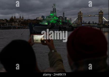 London, Großbritannien. 4. November 2021. Die HMS Belfast ist grün beleuchtet, um die Aufmerksamkeit auf die UN-Klimakonferenz (COP26) zu lenken, die in Glasgow stattfindet. Mehrere andere britische Kulturinstitutionen beteiligen sich ebenfalls an der Aktion, die Teil von Art for Your World ist, einer neuen Bewegung des WWF, die den Kunst- und Kultursektor im Kampf gegen den Klimawandel engagiert. Kredit: Stephen Chung / Alamy Live Nachrichten Stockfoto