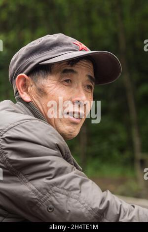 Ein älterer Chinese mit roter Sternkappe posiert im Zhangjiajie National Forest Park, Hunan, China Stockfoto