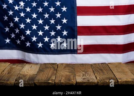 Rustikale leere Holztischplatte mit USA United States of America Flagge auf Hintergrund. Stockfoto