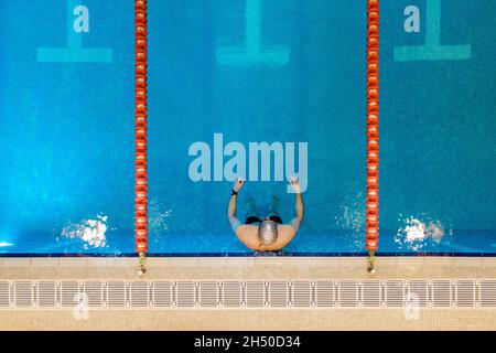 Luftaufnahme, Drohne von oben nach unten von Profi-Schwimmer, Schwimmen im Schwimmbad. Hochwertige Fotos Stockfoto