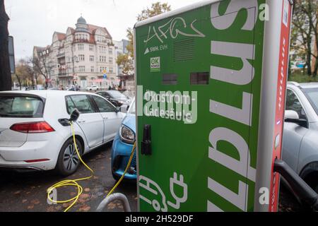 Halle, Deutschland. November 2021. PRODUKTION - 05. November 2021, Sachsen-Anhalt, Halle (Saale): Elektroautos werden an einer Ladestation auf dem Universitätsring in Halle/Saale geladen. Die Lademöglichkeiten für Elektroautos in Sachsen-Anhalt sind überschaubar, einige Nachbarländer sind viel besser positioniert. Foto: Hendrik Schmidt/dpa-Zentralbild/dpa Quelle: dpa picture Alliance/Alamy Live News Stockfoto