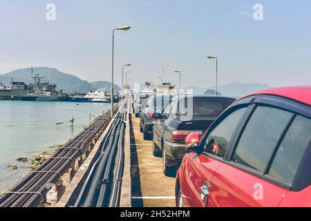 Phuket, Thailand - 26. Dezember 2017 : Eine Reihe geparkter Autos, die sich um Bend in der Pier Road drehen. Stockfoto