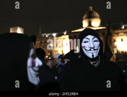 London, Großbritannien. Freitag, 5. November 2021. Maskierte Demonstranten während des Millionen-Maske-Marsches auf dem Trafalgar-Platz in London, England. Foto: Isabel Infantes/Alamy Live News Stockfoto