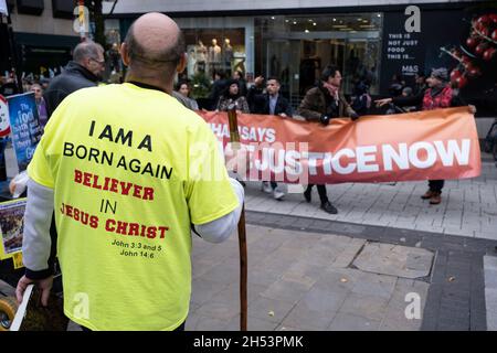 Wiedergeboren ruft der christliche Straßenprediger den Protestierenden zu, dass der Planet ohne Gott nicht gerettet werden kann, während sich die Demonstranten am 6. November 2021 in Birmingham, Großbritannien, für die Unterstützung und den Schutz der biologischen Vielfalt beim ‘Global Day of Action’-marsch der COP26 Coalition und bei der Kundgebung für Klimagerechtigkeit versammeln. Während sich die Staats- und Regierungschefs zur Klimakonferenz der Vereinten Nationen versammeln, marschierten Menschen in Städten auf der ganzen Welt für starke, dringende Maßnahmen, die gegen Natur und Klima ergriffen werden müssen. Der Protest hat das Ziel, unsere Landschaften und unsere wilden ‘zu schützen, wiederherzustellen und effektiv zu verwalten Stockfoto