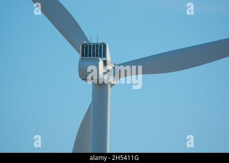 Windturbinen im offenen Gelände an windigen Tagen mit dunklen Wolken am Himmel. Alternative Stromerzeugung. Stockfoto