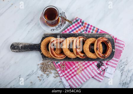 Türkische Bagel Kandil simiti mit Tee (Stapel Gebäck). Ein herzhaftes, ringförmiges kandil simidi-Gebäck, das in der Regel an heiligen Nächten gegessen wird. Stockfoto