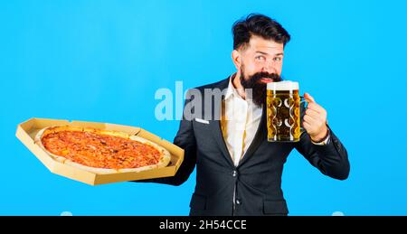 Bärtiger Mann mit leckerer Pizza und Bier. Fast Food. Restaurant oder Pizzeria. Italienisches Essen. Pizzazeit. Stockfoto