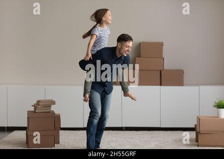 Aufgeregt Vater Piggy Unterstützung Tochter, freute Umzug in neues Zuhause Stockfoto