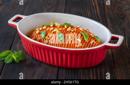 Gebackener hasselback-Kürbis, mit Karamell in der Backform glasiert Stockfoto