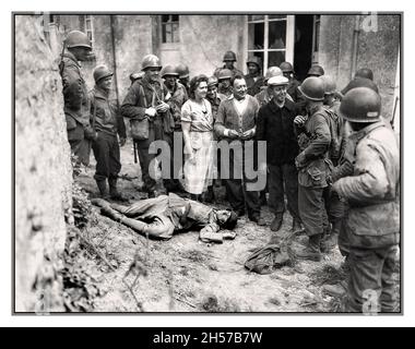 D-Day Advance und französische Befreiung in der Normandie amerikanische Soldaten mit befreiter Gruppe von Einwohnern der französischen Normandie mit einer grausamen Leiche eines Nazi-Soldaten der deutschen Wehrmacht 1944 Normandie Frankreich Stockfoto