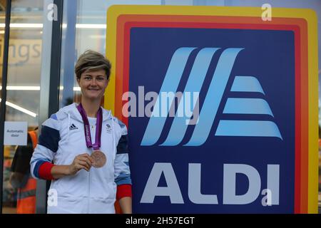 London, Großbritannien. Oktober 2021. Die britische Eishockey-Bronzemedaillengewinnerin Sally Walton posiert für ein Foto, während sie ihre Medaille vor dem neuen Aldi-Store im Norden Londons hält.im Sommer bestätigte der Budget-Supermarkt die Pläne, mehr als 450 neue Geschäfte in ganz Großbritannien, 400 in England, 30 in Wales und 20 in Schottland zu eröffnen. Schaffung von 2000 Arbeitsplätzen. Aldi ist Großbritanniens fünftgrößtes Supermarktgeschäft. Kredit: SOPA Images Limited/Alamy Live Nachrichten Stockfoto