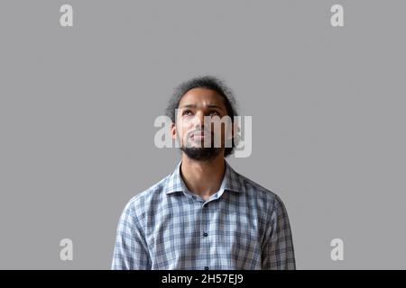 Serious junge Kerl in casual stehend isoliert auf grauem Hintergrund Stockfoto
