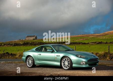 Aston Martin DB7 Vantage V12 parkte auf einer Landstraße unterhalb des Moorlandes im Peak District Stockfoto