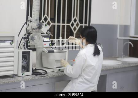 Asiatische Wissenschaftlerin, die einen Rotationsverdampfer bediente, um im Labor ein Experiment zu machen Stockfoto