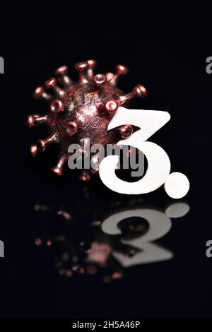 Coronavirus-Modell mit der Zahl 3, Symbolfoto dritte Infektionswelle Stockfoto