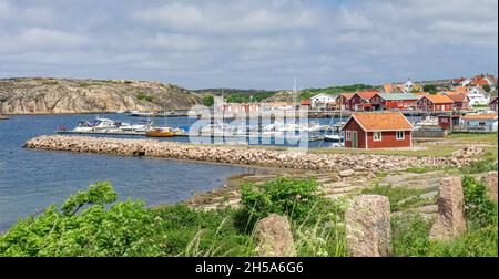 Smögen, Schweden - 9. Juni 2021: Eine Bucht am Eingang der Insel Smögen an der Westküste Schwedens mit Booten und typischen roten Häusern Stockfoto