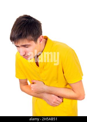 Der junge Mann spürt auf dem weißen Hintergrund vereinzelte Bauchschmerzen Stockfoto