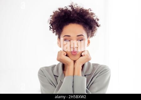 Foto von jungen hübschen afro Mädchen Erwachen Pouted Lippen senden Luftkuss romantische Datum verträumte Freundin drinnen Stockfoto