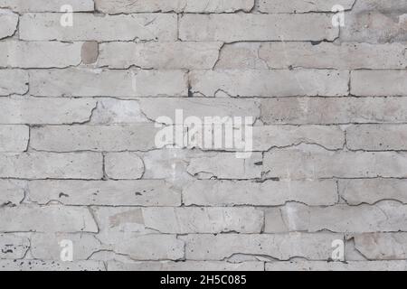 Graue Betonwand mit Ziegelmuster Stockfoto