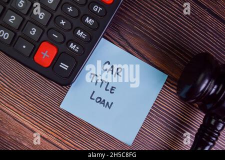 Car Title Loan Schreiben Sie auf Haftnotizen isoliert auf Holztisch. Stockfoto