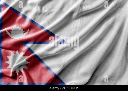 Winkende detailreiche Nationalflagge Nepals Stockfoto