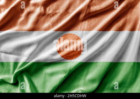 Winkende detaillierte Nationalflagge von Niger Stockfoto