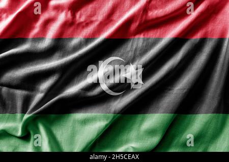 Winkende detaillierte Nationalflagge Libyens Stockfoto