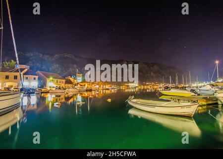 Kotor Bay Montenegro mit Booten und Häusern am Ufer, Berge im Hintergrund. Stockfoto