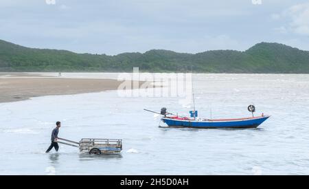 Chantaburi / THAILAND - Okt 13, 2021: Die Einheimischen ziehen den Holzkarren, um den Müll aus dem Meer und fast dem Küstenbereich zum Recycling zu sammeln. Stockfoto