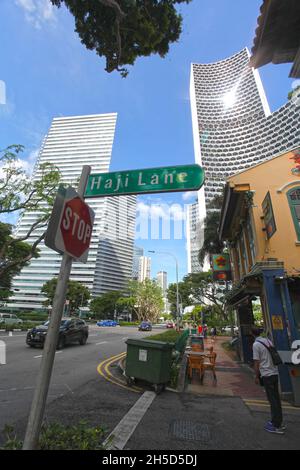 Ein grünes Straßenschild für die „Hji Lane“ im Viertel Kampong Glam von Singapur mit der North Bridge Road auf der linken Seite. Stockfoto