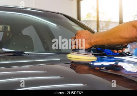 Mann bei der Arbeit Zum polieren, beschichten Autos. Stockfoto