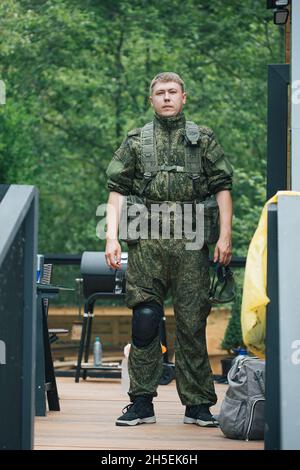 Voll ausgestattete Militärangehörige mit automatischen Waffen, die sich bereit machen, Airsoft-Strikeball zu spielen Stockfoto