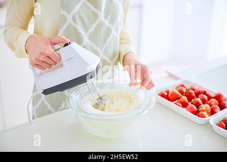 Japanische Frau macht Kuchen in der Küche Stockfoto