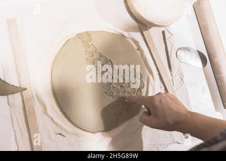 Töpferkünstler Formen auf Ton zum Formen. Kreative Handarbeit. Keramikstudio. Draufsicht. Stockfoto