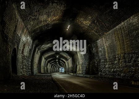 Ein Bild mit hohem Dynamikbereich, das im stillliegenden Cressbrook Tunnel auf dem Monsal Trail aufgenommen wurde. Diese wurde einst von Zügen der Midland Railway Lin genutzt Stockfoto