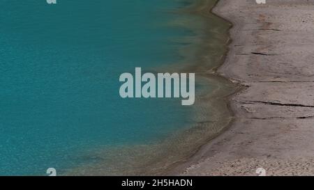 Blick auf das sandige Ufer des Lake Louise mit charakteristischem türkisfarbenem Wasser im Banff National Park, Alberta, Kanada in den Rockies. Stockfoto