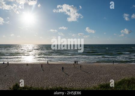 KURISCHE NEHRUNG, Kaliningrad Juni 2021 Eine Gruppe von Menschen geht am Strand der Kurischen Nehrung in der Nähe der Ostsee spazieren. Stockfoto