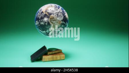 Globus auf einem Magnetständer und alte Bücher Stockfoto