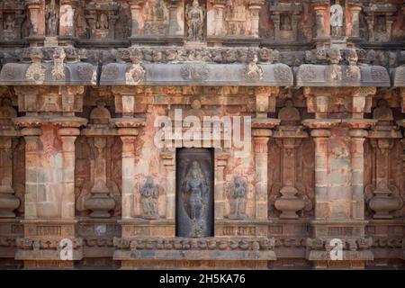 Nische mit hinduistischer Gottheitsschnitzerei in Steinmauer des Dravidian Chola-Ära Airavatesvara-Tempels; Darasuram, Tamil Nadu, Indien Stockfoto